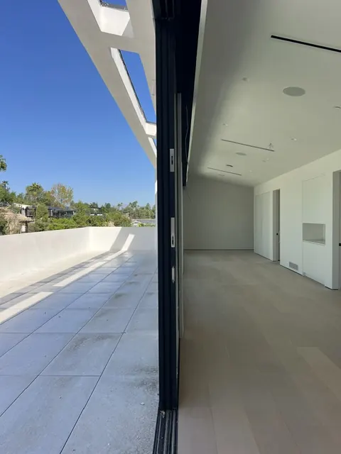 Don Juan terrace and adjacent interior separated by a broad sliding glass opening