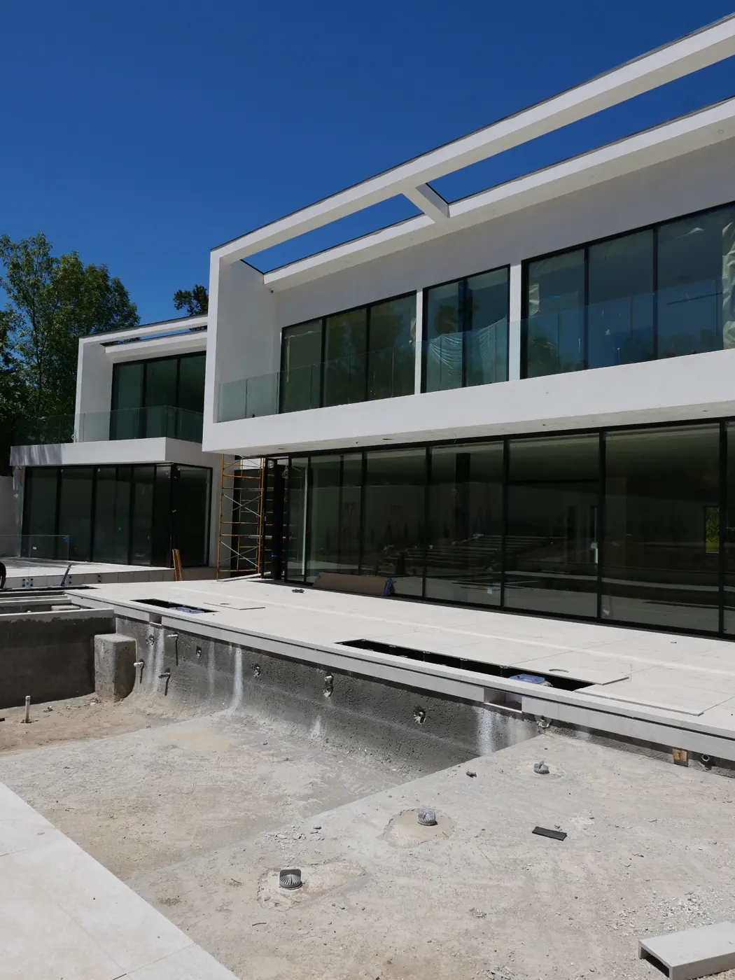 Rear glazed elevation and pool basin under construction