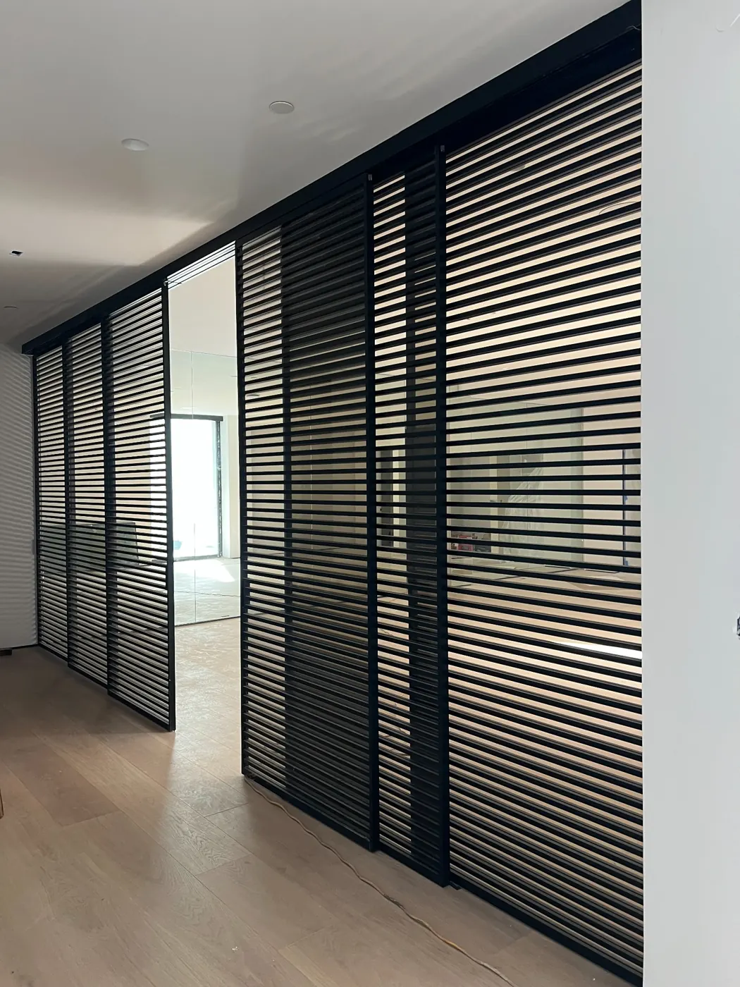 Boffi pocket sliding door with horizontal black slats at the gym