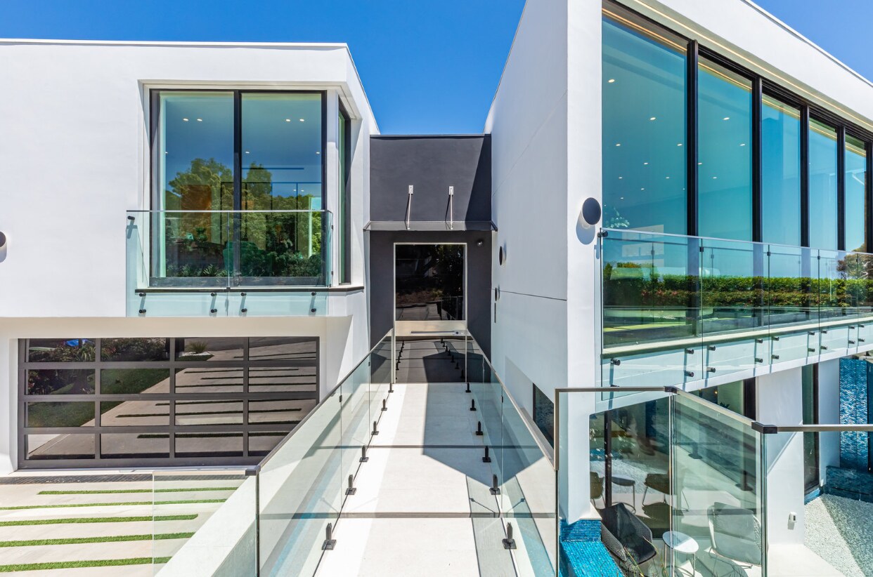 Glass entry bridge between the white residential volumes