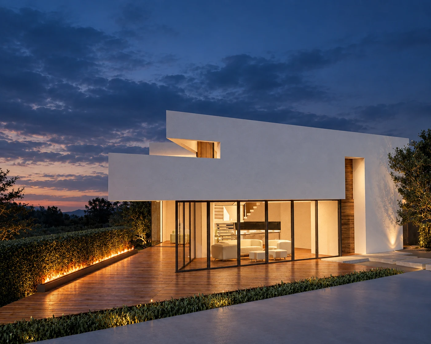 Terrace view of the interlocking white roof planes and large glazed living area at dusk