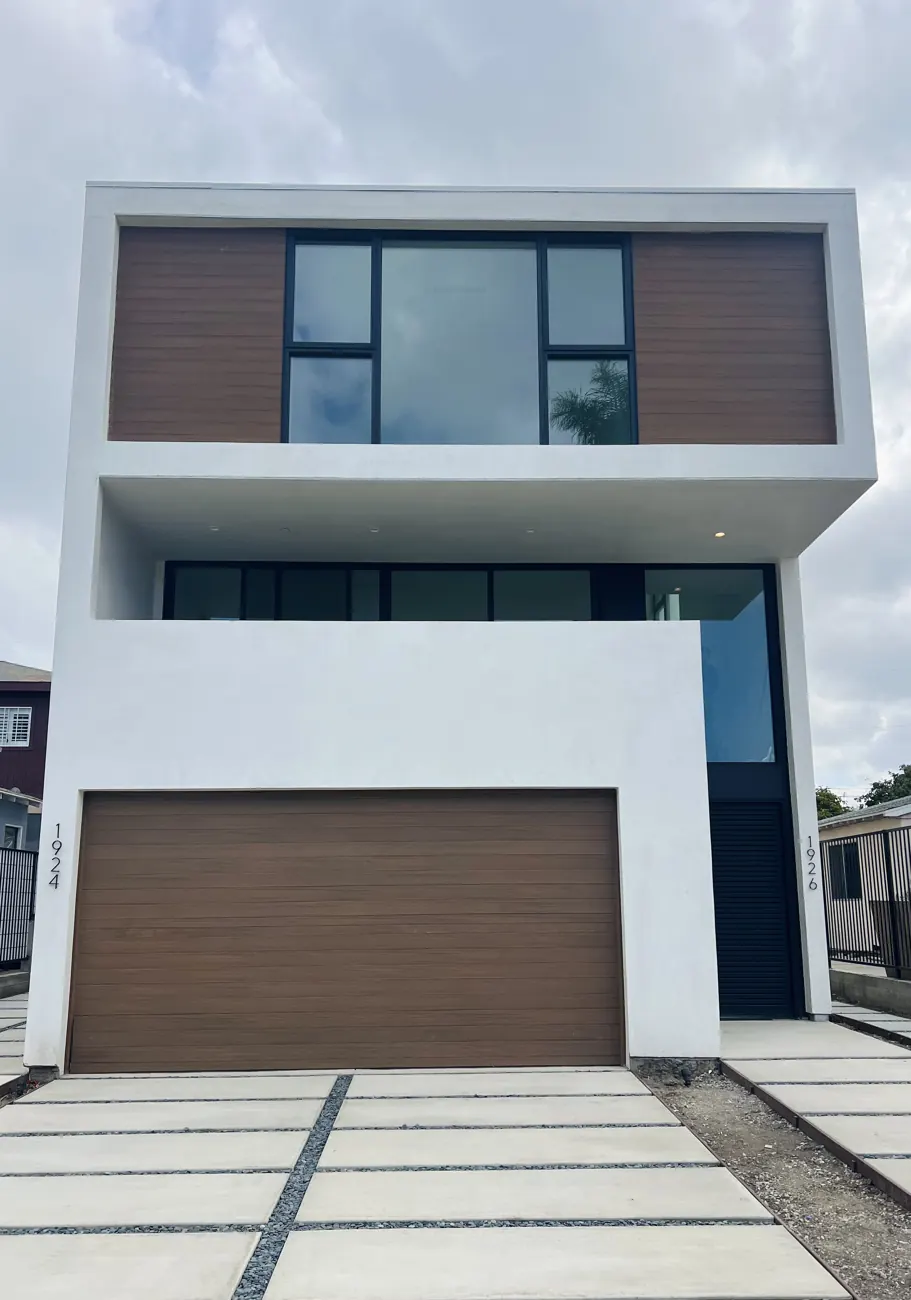 Other Federal condominium front elevation with wood panels and garage