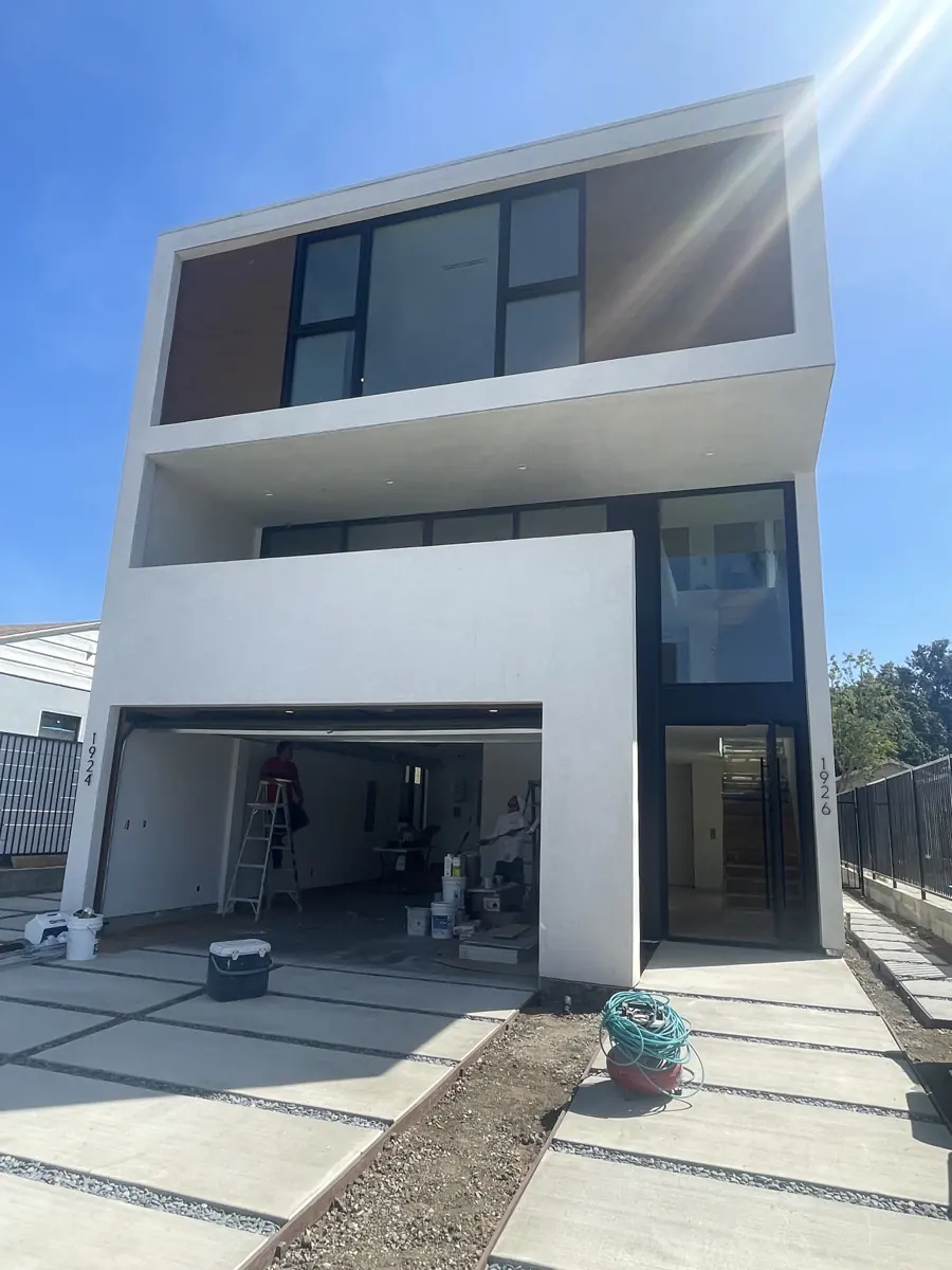 Federal condominium front elevation with a white frame, recessed entry and garage