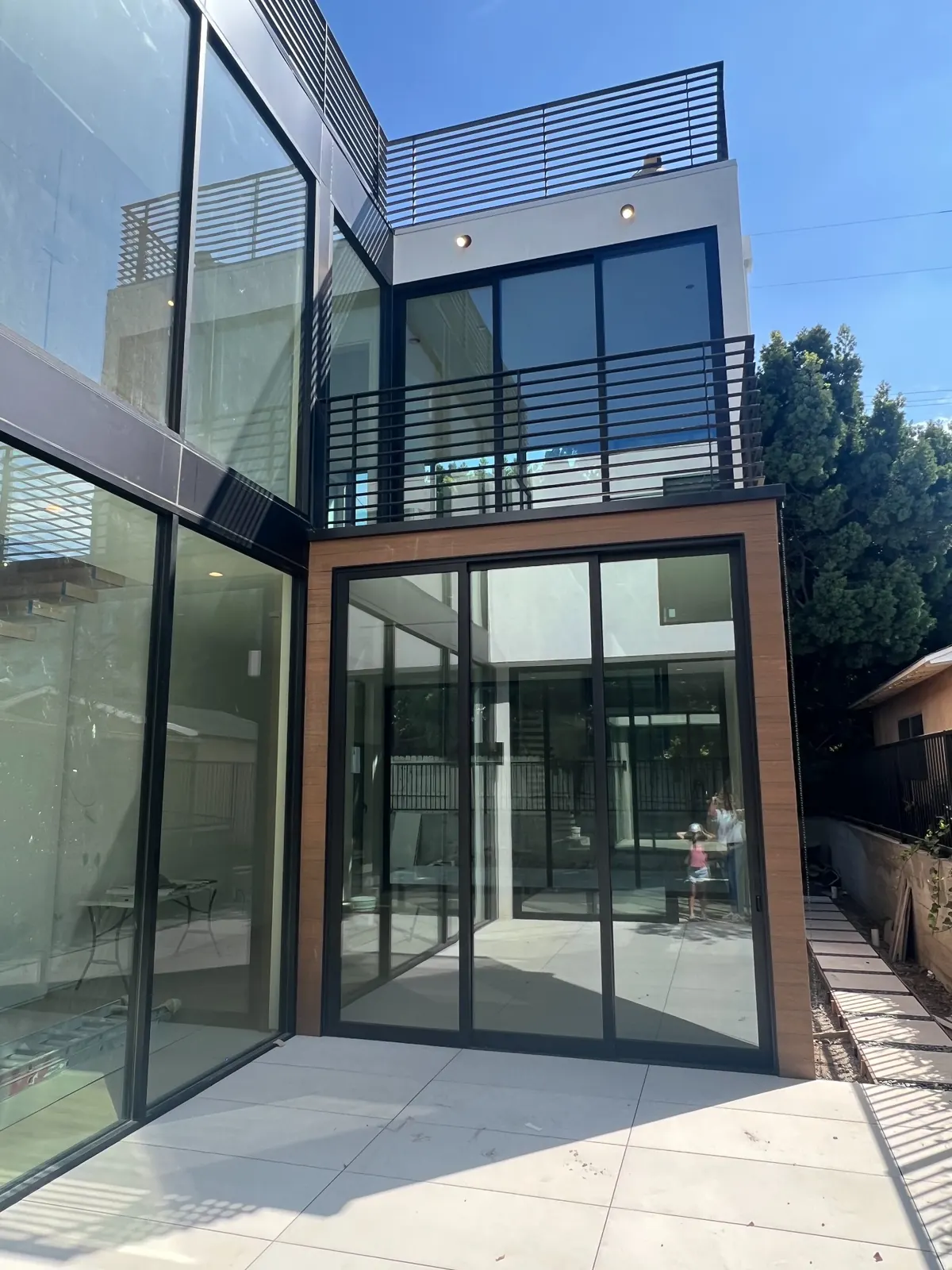 Federal courtyard elevation with tall dark glazing, wood cladding and upper terrace railings