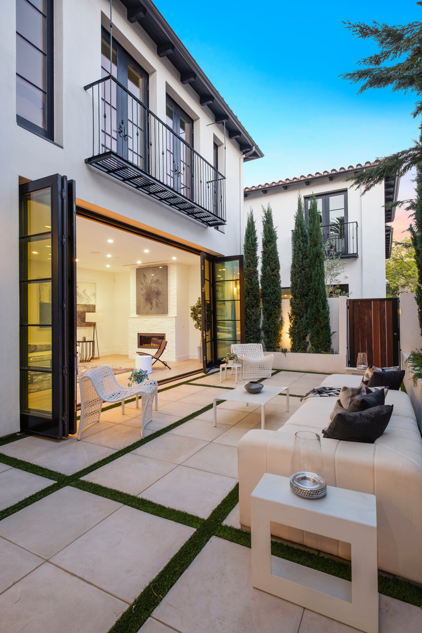 Courtyard terrace framed by folding doors and upper balconies
