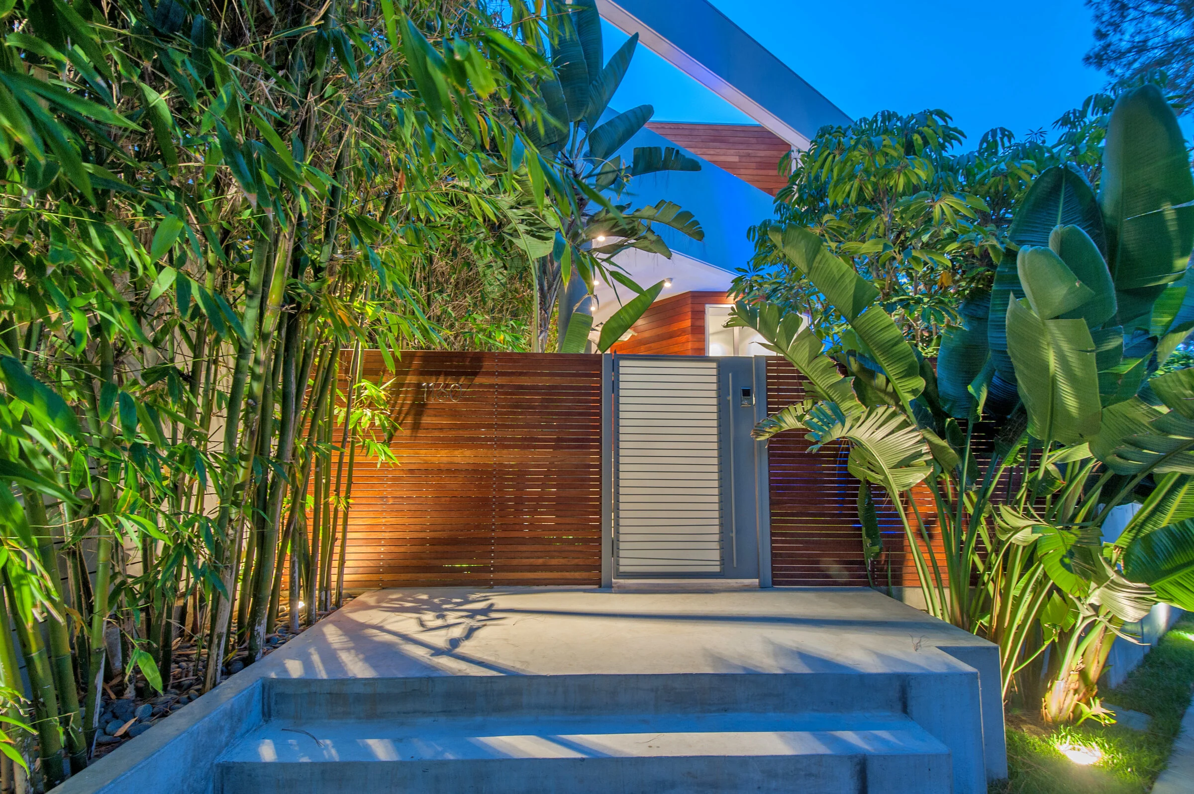 Landscaped entrance illuminated after sunset