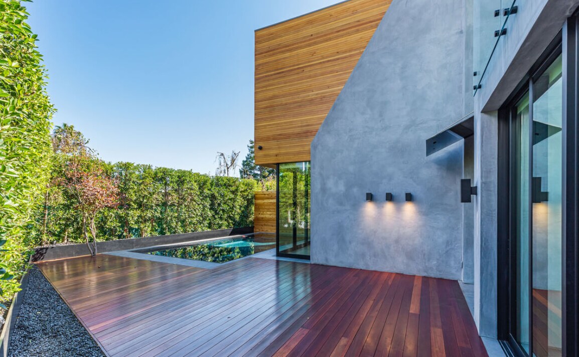 Wood terrace meeting a shallow water court